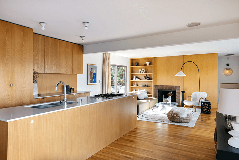 An open galley-style kitchen looks onto the living room and dining area.