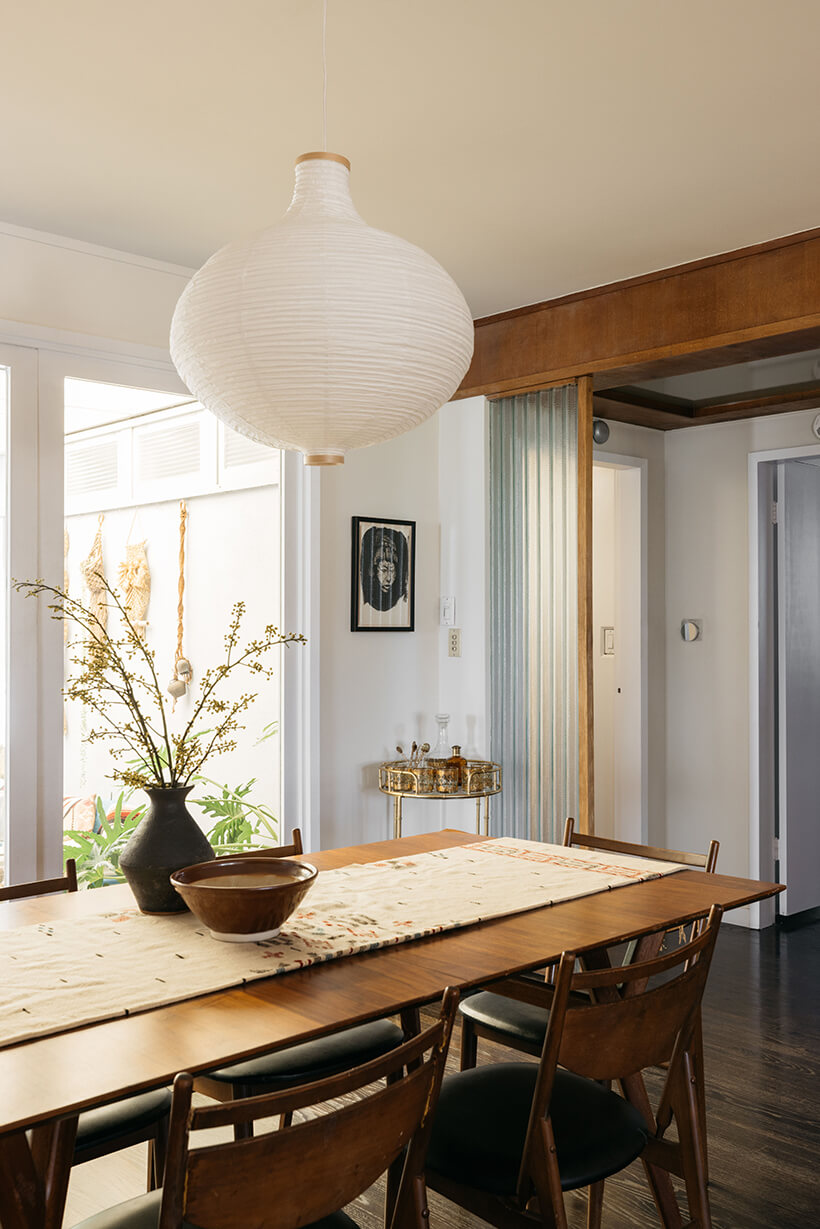 The dining area sits in front of a wall of large doors looking onto the courtyard.