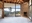 A down to the studs interior with a brick fireplace with views of the surrounding hills.