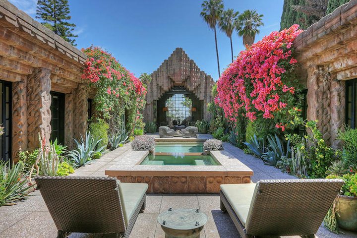 Pool middle of Lloyd Wright’s Alluring Sowden House with beautiful flowers