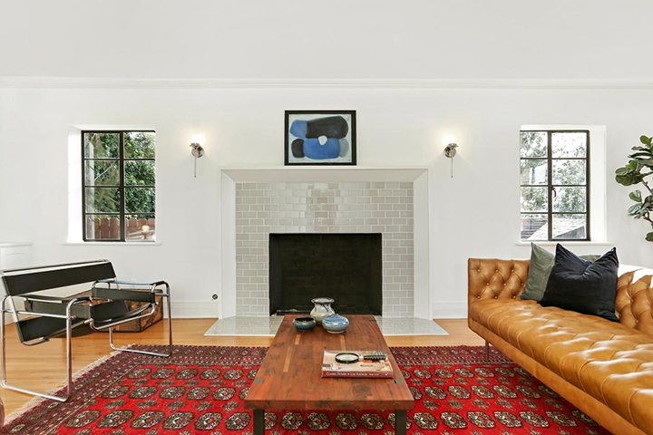 The living room and a fireplace of Annon’s Brick House in Silver Lake