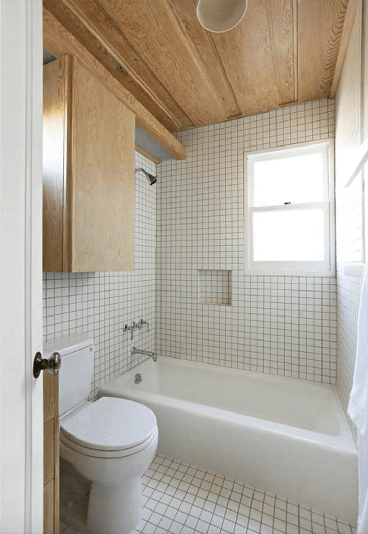 Bathroom with small tiles and a small window