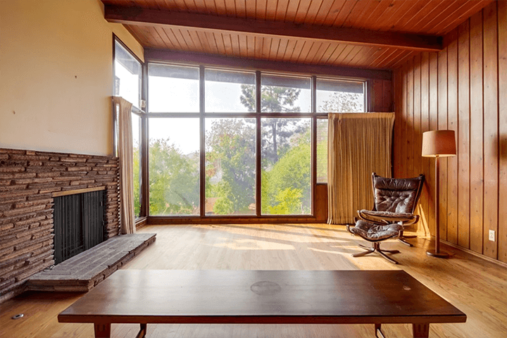 The living room and a fireplace have a great view of the outside.