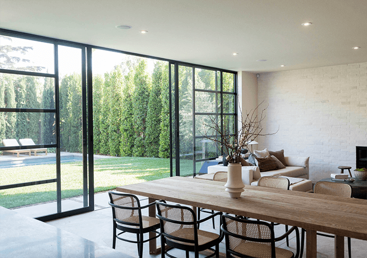 The dining area has a sliding glass door with an outside view.
