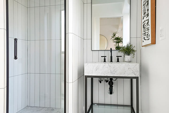 Bathroom with marble tiles and a mirror