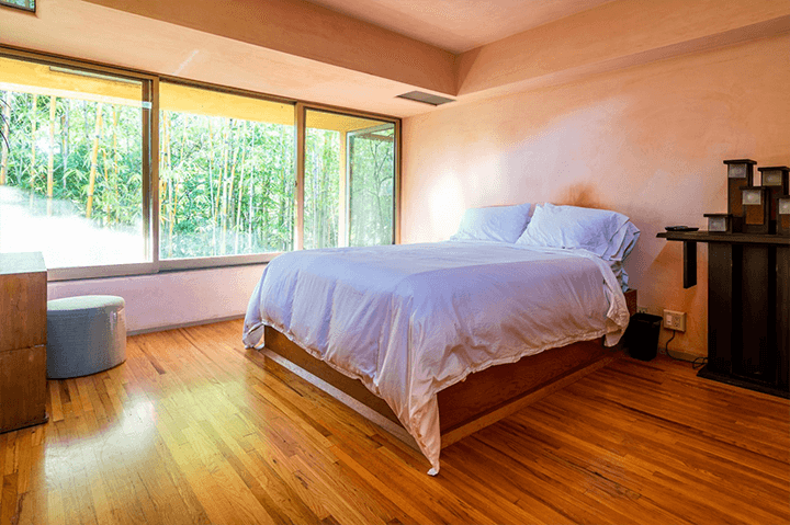 The bedroom and an outside view with a wooden floor