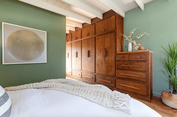 The bedroom, wooden wardrobe, and shelf
