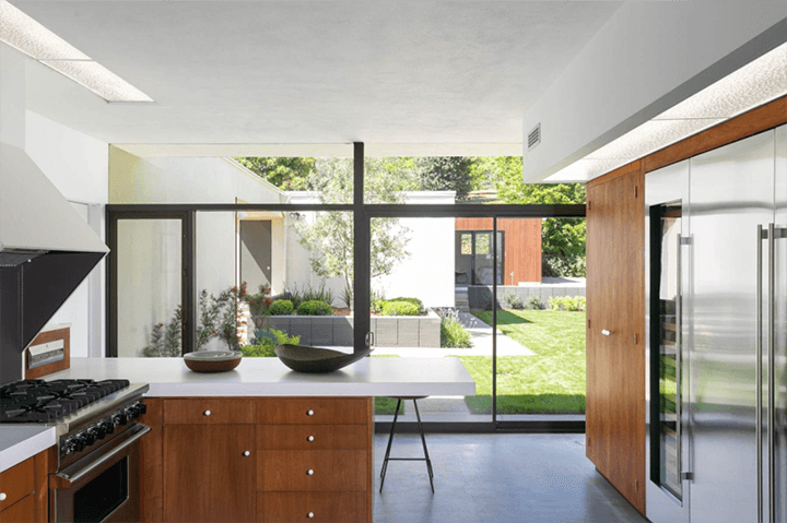 The modern kitchen by John F. Galbraith with a large glass sliding door