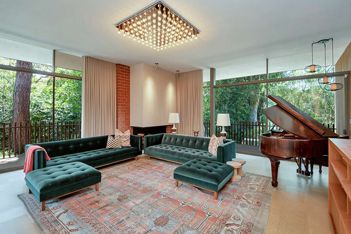 The main living room of Robert Skinner midcentury in Beverly Hills with a piano and a large outside view