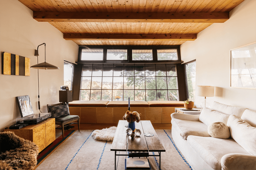 The living room of Architectural Cabin in Mount Washington with wooden ceiling and glass window