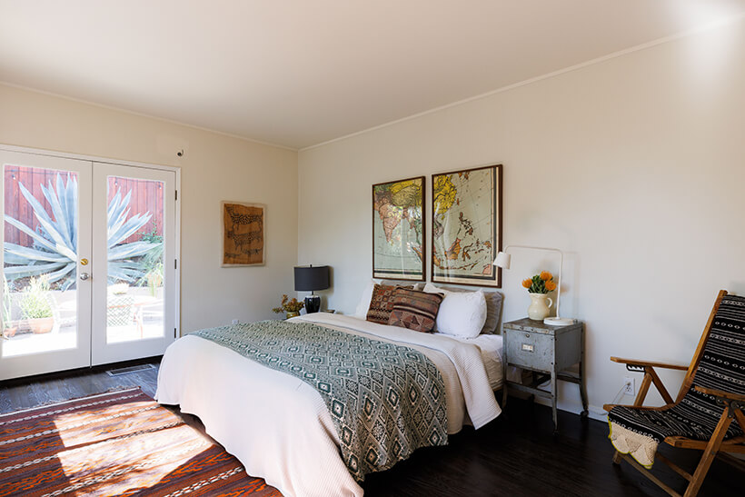 The main bedroom has an ensuite bathroom and French doors leading the to landscaped backyard.
