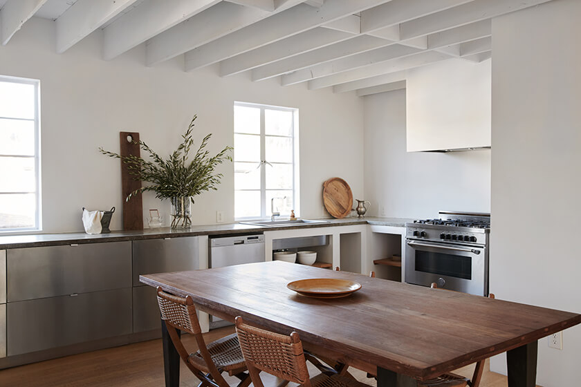 The kitchen and dining space have a wooden table