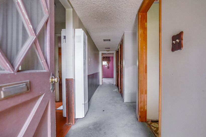 The middle room of Van Nuys Fixer in a Bidding War with concrite floor