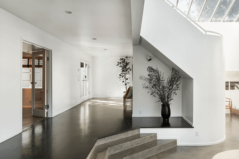 The living room and staircase of Jon J. Jannotta Modern House in the Hollywood Hills